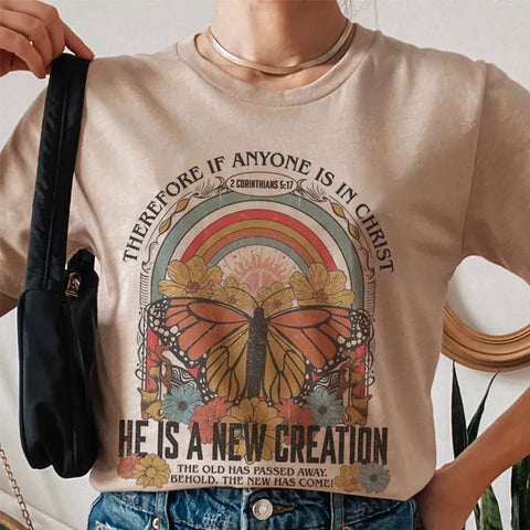 Photo of woman wearing beige he is a new creation tshirt