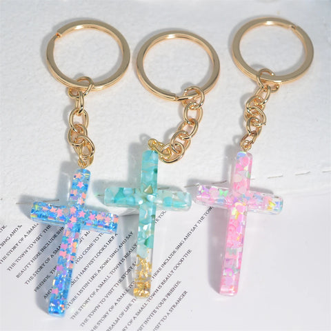 Photo of three resin cross keychains