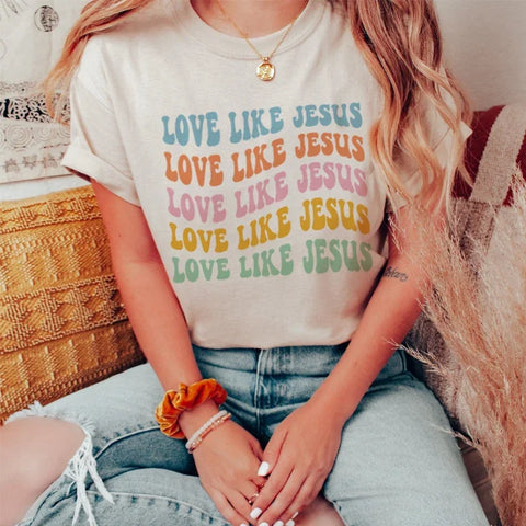 Photo of woman wearing beige love like jesus shirt