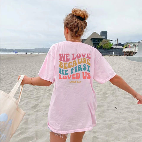 Photo of woman wearing pink he first loved us tshirt
